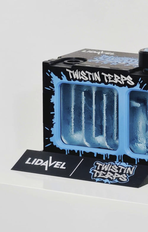 The Box V2 — TwistinTerps × Lidavel Artist Series, front view close-up of the blue drip graffiti artwork and frosted window, with Lidavel × TwistinTerps card